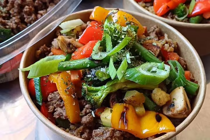 Colorful vegetable and beef bowl showcasing fresh ingredients, a highlight on the 3-hour food and drink tour menu.