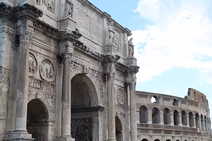 Close-up of the Colosseum's ancient arches and detailed carvings showcasing Roman architecture.