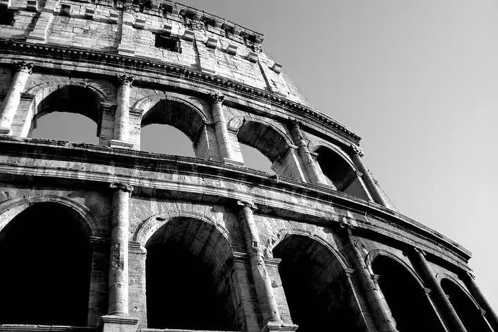 Black and white image of the Colosseum's arches, capturing the timeless beauty of Rome's ancient landmark.