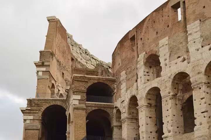 Close-up of the Colosseum arches in Rome, a highlight on the walking tour with hosted Vatican access
