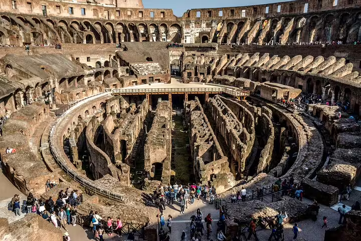 Inside the Colosseum arena with underground hypogeum ruins, included in Rome entrance pass tour