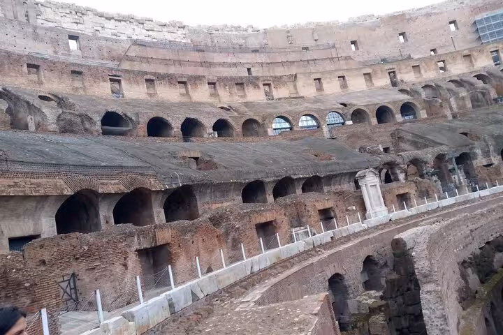 Interior of the Colosseum showcasing ancient architecture and seating, highlighting Rome's historic underground tour.