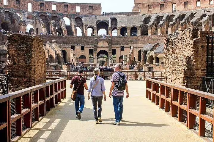Small group walking onto the exclusive Colosseum gladiator arena floor during a guided tour of ancient Rome’s iconic amphitheatre