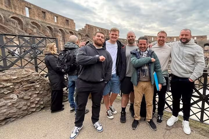 Visitors pose inside the iconic Colosseum, capturing the excitement of a guided tour through ancient Roman history.