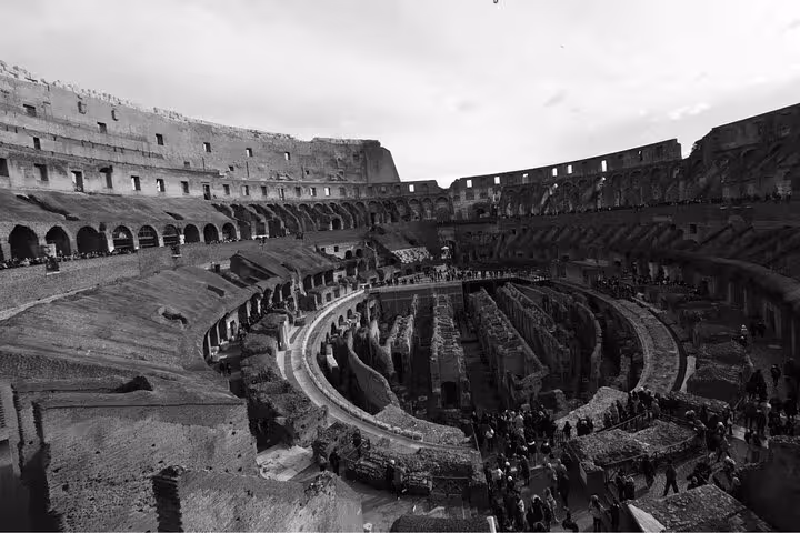 Interior view of the Colosseum, highlighting the iconic ancient amphitheater's intricate tiers and arches.