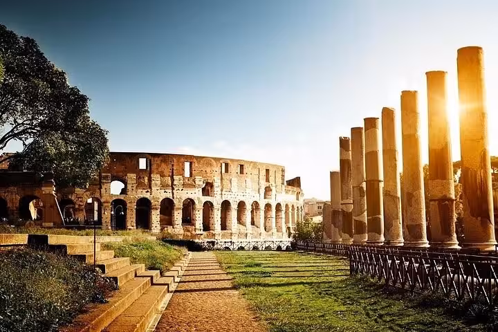 Colosseum and Roman Forum columns at sunrise, iconic stop on Rome walking tour with Vatican access