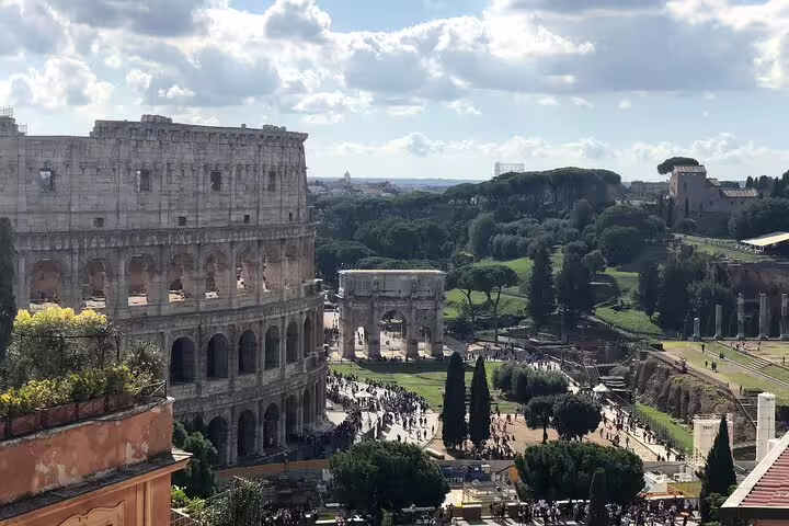 Aerial view of the Colosseum, Arch of Constantine and Roman Forum crowds on a fast track guided tour in Rome