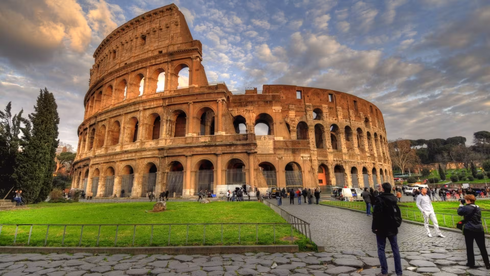 Scenic view of the iconic Colosseum in Rome under a vibrant sky, perfect for exploring ancient Roman history.