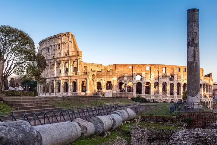 Sunlit exterior of the Colosseum in Rome at golden hour, visited on a private arena floor tour with expert local guide