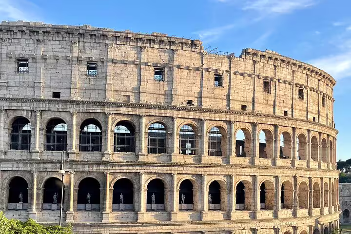 Close-up view of the Colosseum at sunset captured on a Rome private double decker open bus panoramic guided tour