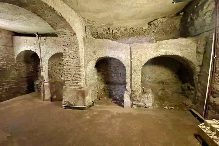 Ancient underground arches and brick corridors beneath the Rome Colosseum, explored on a guided Roman Forum and Palatine Hill tour