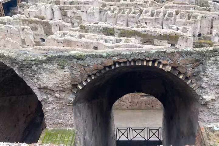 Close-up of the Colosseum's ancient arches and passageways, offering a glimpse into Rome's underground history.