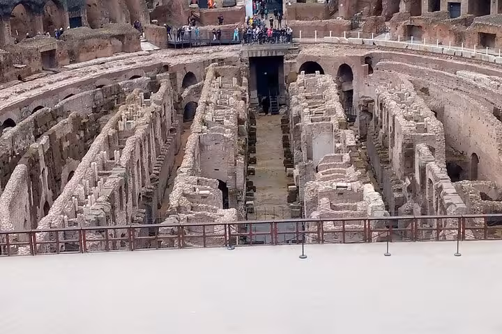 View of the Colosseum's intricate underground chambers, showcasing ancient Roman architecture on a small group tour.