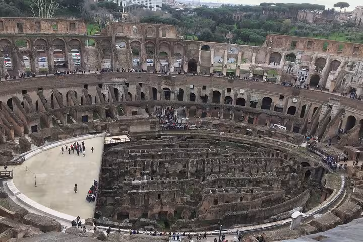 Aerial view of the Colosseum, showcasing its ancient architecture and underground levels on the guided tour.