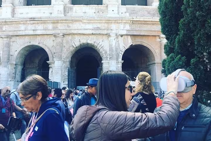 Tourists engaging in a Colosseum virtual reality experience, enhancing their visit to the iconic Roman landmark.