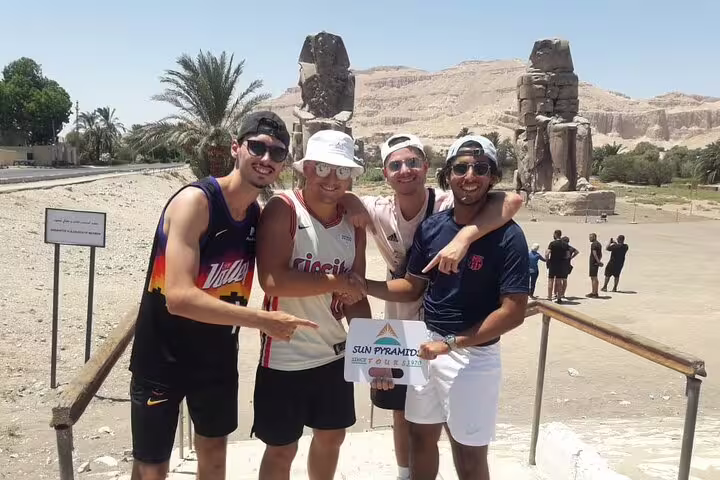 Travelers pose at Colossi of Memnon, Luxor stop on 4 nights 5 days Nile cruise from Luxor itinerary