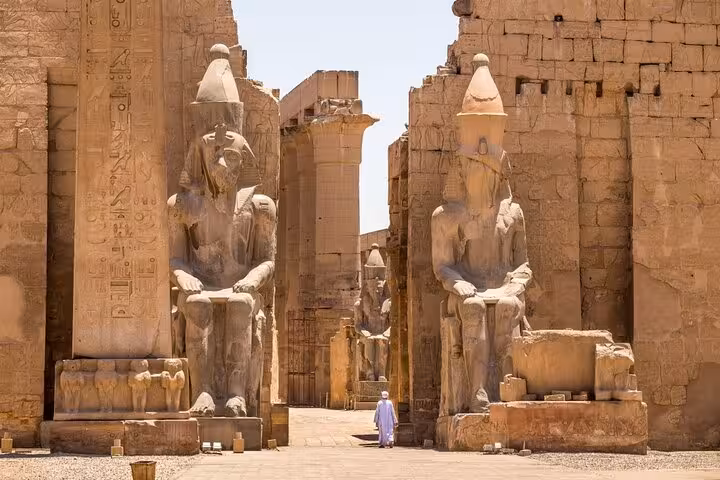 Colossi of Memnon statues at Luxor West Bank entrance, must-see sight on Cairo Luxor Aswan group tour