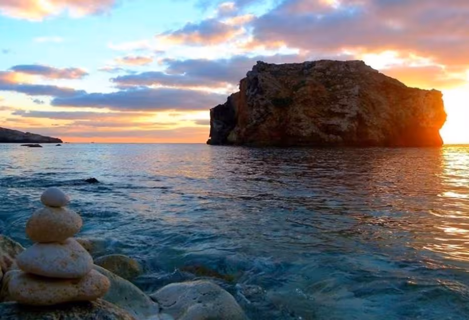 Sunset view over Comino coastline and rock formation, Malta Blue and Crystal Lagoons cruise with sea caves
