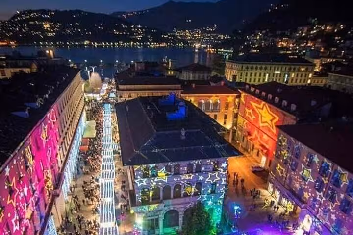 Como waterfront at night with festive lights, ideal stop on Milan to Lake Como, Bellagio and cruise tour