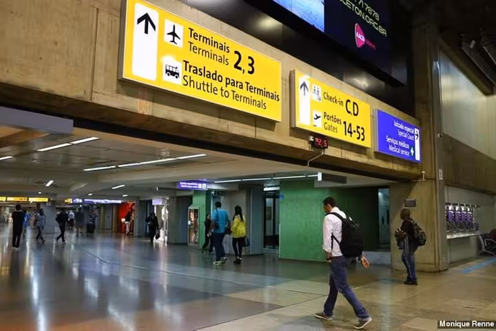 Interior view of Congonhas Airport in São Paulo showing directional signs for terminals and check-in areas.