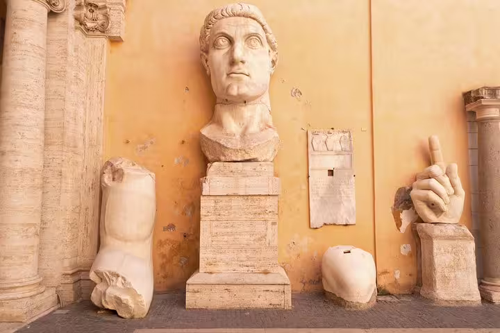 Colossal fragments of Constantine’s statue displayed in the courtyard of Rome’s Capitoline Museums on a private guided tour