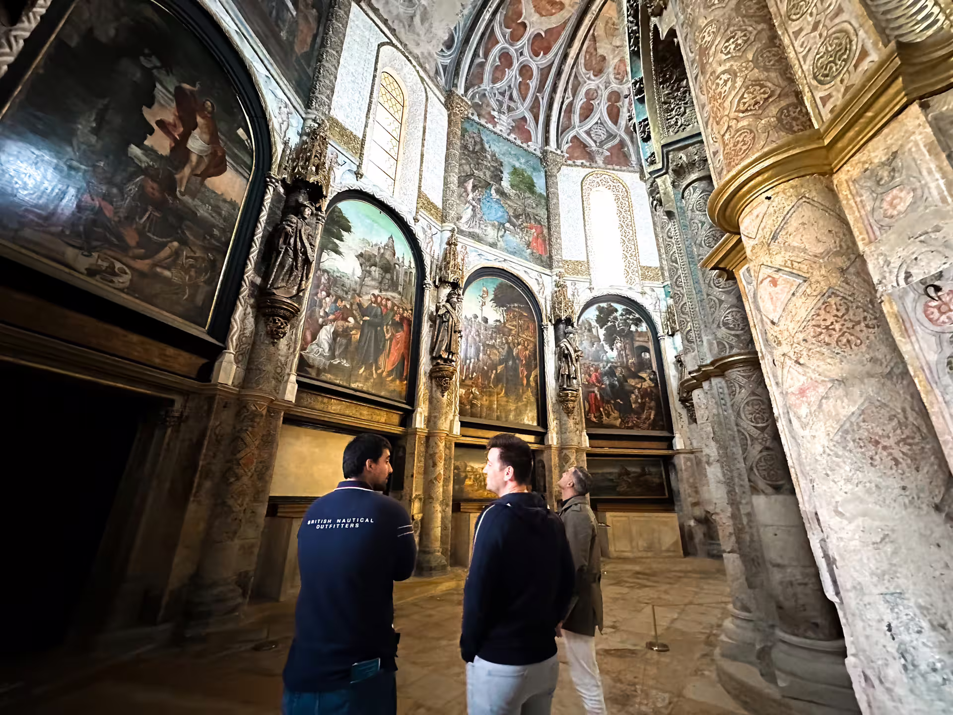 Tourists exploring the intricate frescoes and architecture inside the Convent of Christ in Tomar, a stop on Lisbon to Porto tour.