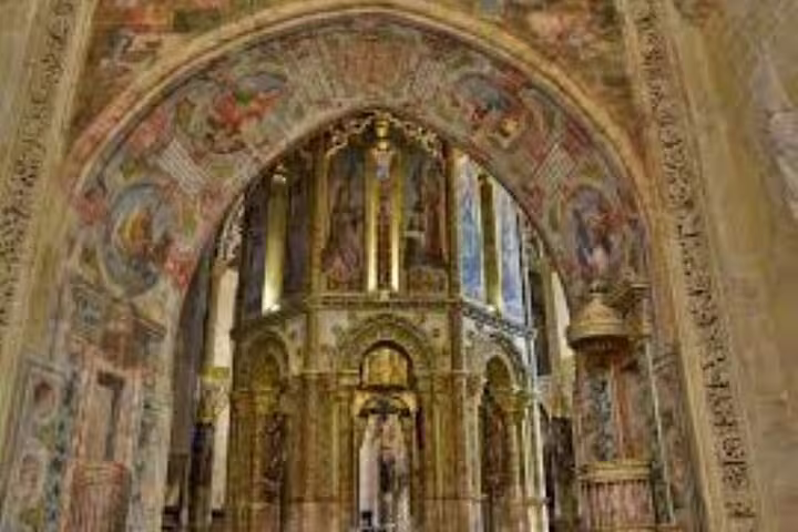 Intricate frescoes and arches inside the Convent of Christ in Tomar, highlighting medieval artistry and religious history.