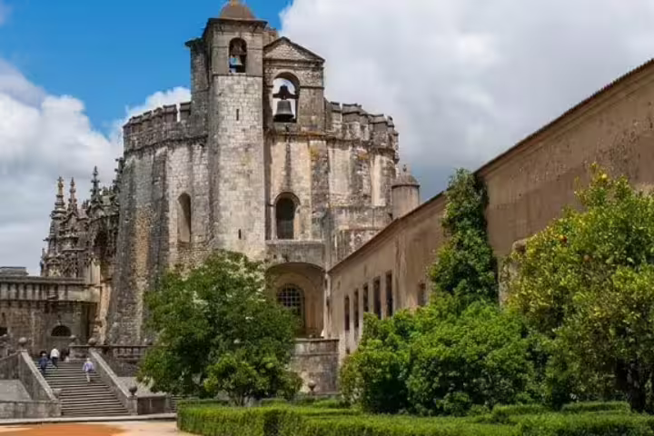Historic Convento de Cristo in Tomar, Portugal, showcasing medieval architecture on a sunny day, ideal for private Lisbon tours.