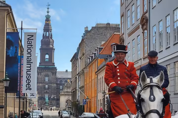 Copenhagen tour with horse-drawn carriage near Nationalmuseet and Christiansborg Palace on a sunny day.