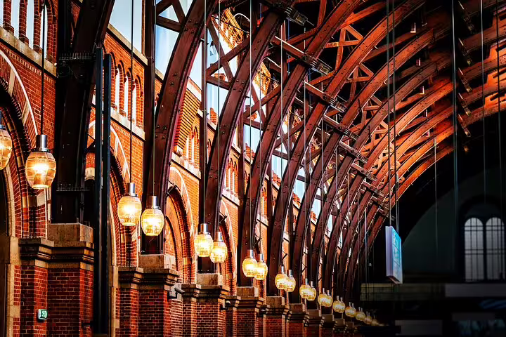 Historic interior of Copenhagen's Vesterbro station with elegant arches and warm lighting, featured in private tour.