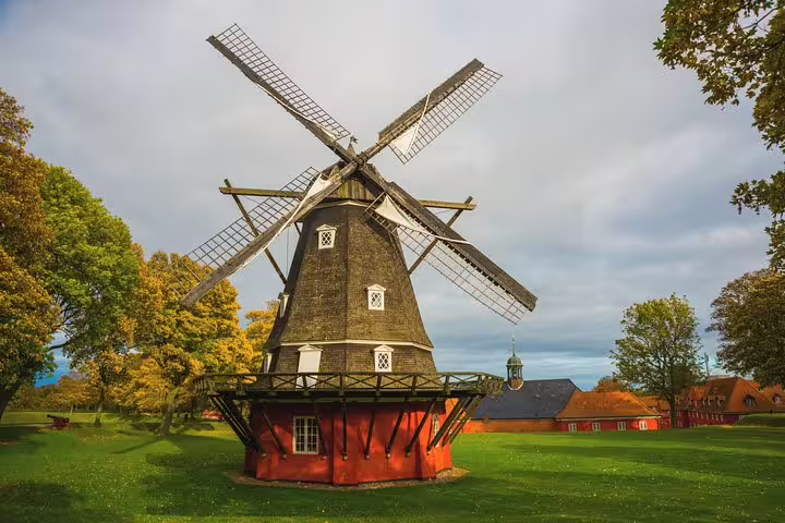Historic windmill in a lush green park setting, perfect for exploring on a Copenhagen Private Full Day Tour.
