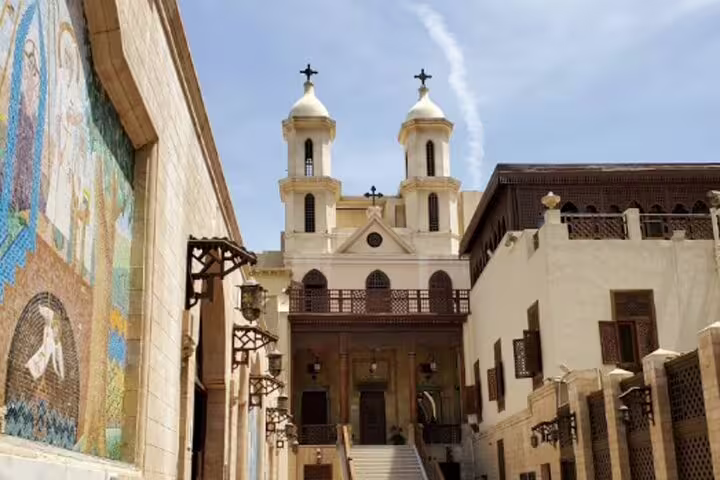 Coptic Cairo church facade with twin bell towers and mosaics, part of private Cairo museum and mosque tour