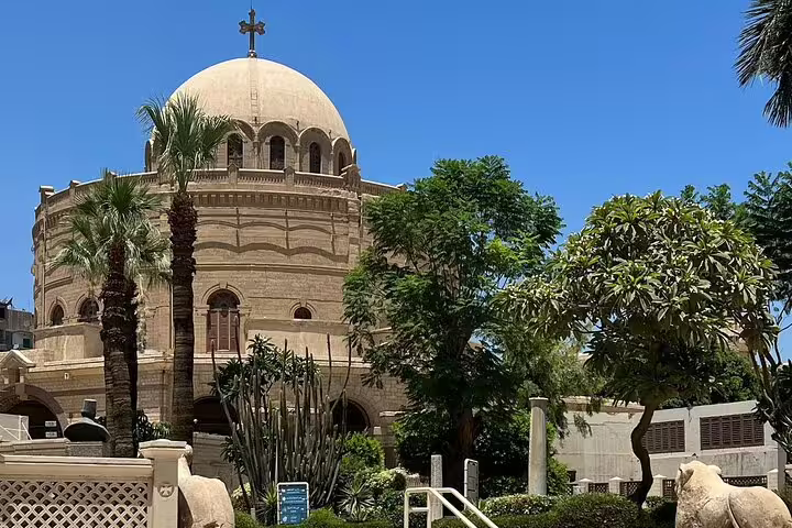 Coptic Cairo church exterior with domed roof and palm trees, stop on Cairo Citadel and Khan El-Khalili day tour