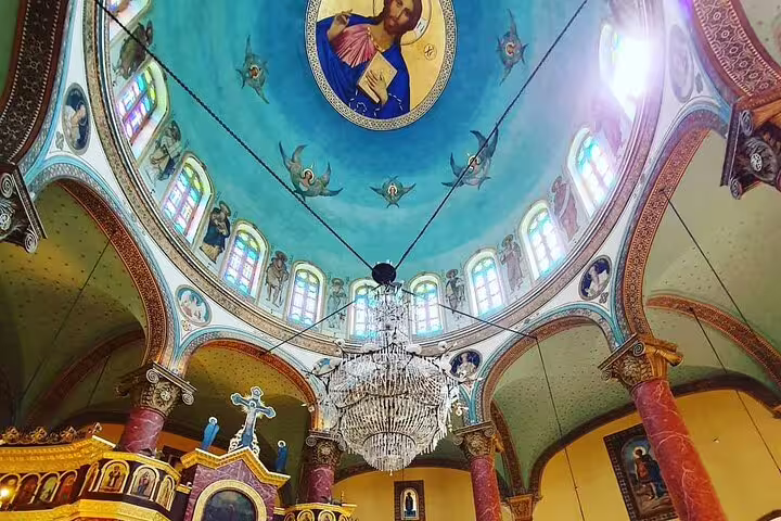 Ornate Coptic church interior dome fresco and chandelier, highlight of private Coptic Cairo and Cave Church tour