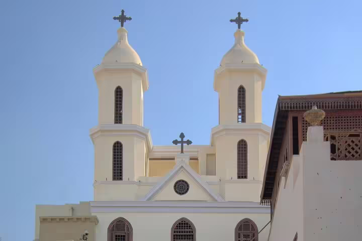 Twin-towered Coptic church facade in Old Cairo under blue sky, stop on private Coptic Cairo tour itinerary