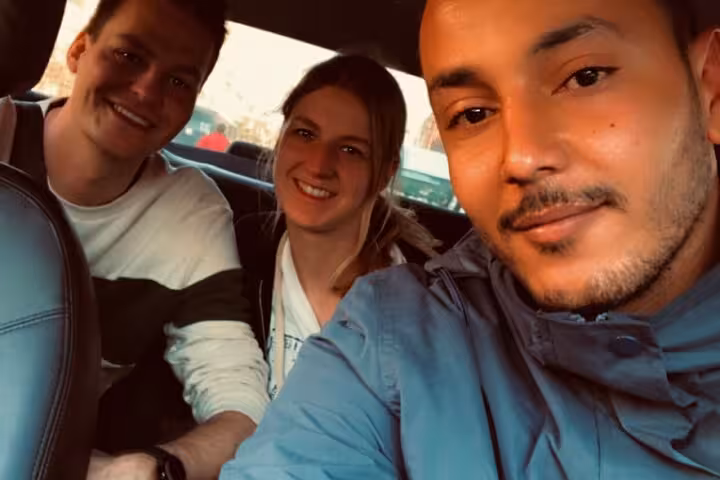 Travelers with local guide in Cairo car transfer for Coptic Cairo, Muizz Street and Khan El Khalili bazaar day tour