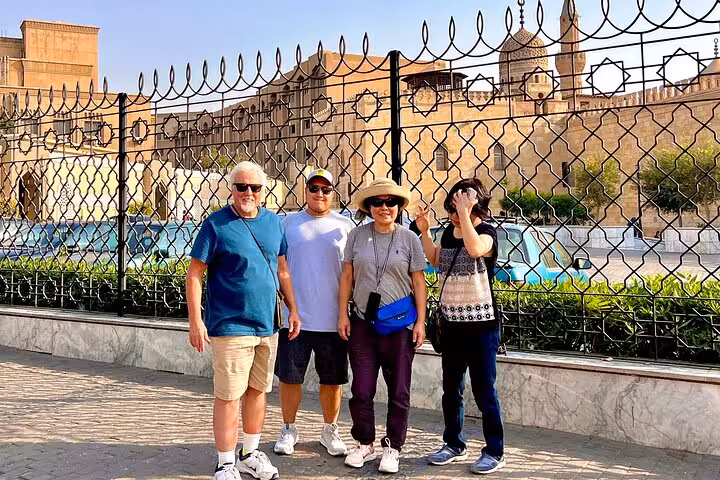 Tour group photo near historic Islamic Cairo walls by Al-Muizz Street and Khan el Khalili bazaar
