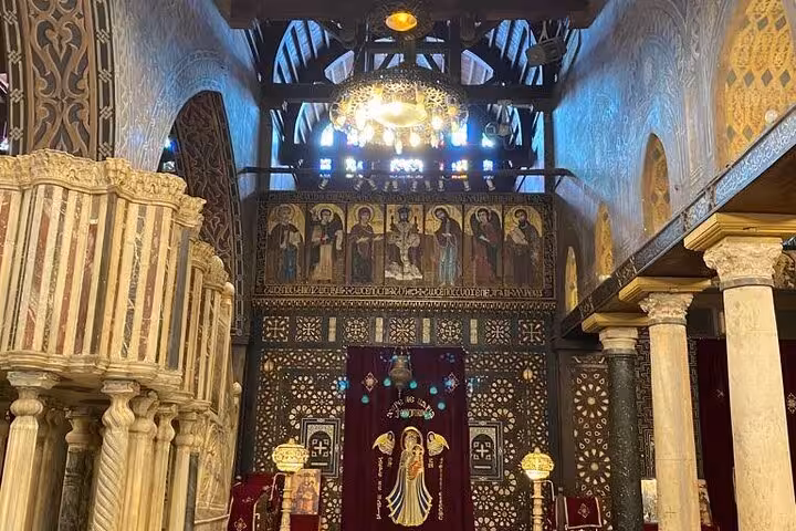 Ornate Coptic church interior in Old Cairo with icons and carved screens, a hidden gem on Cairo culture and felucca tour