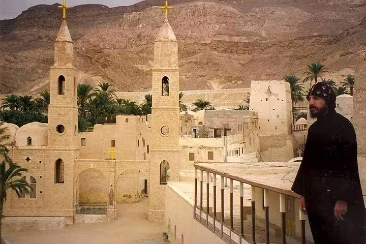 Coptic monk overlooking St Antonius Monastery complex in the Red Sea Mountains on a private full-day tour