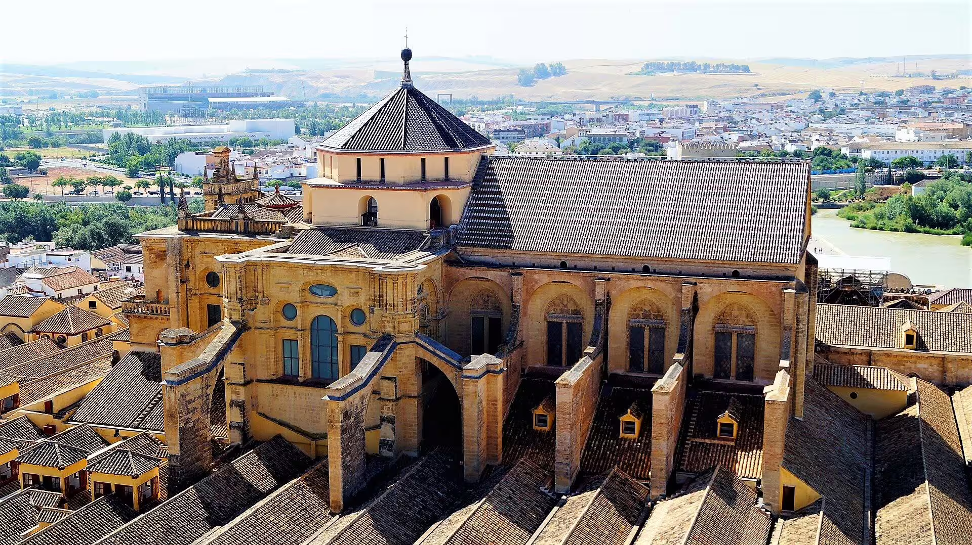 Aerial view of the Mezquita-Catedral of Cordoba by the Guadalquivir River, key stop on a private walking tour