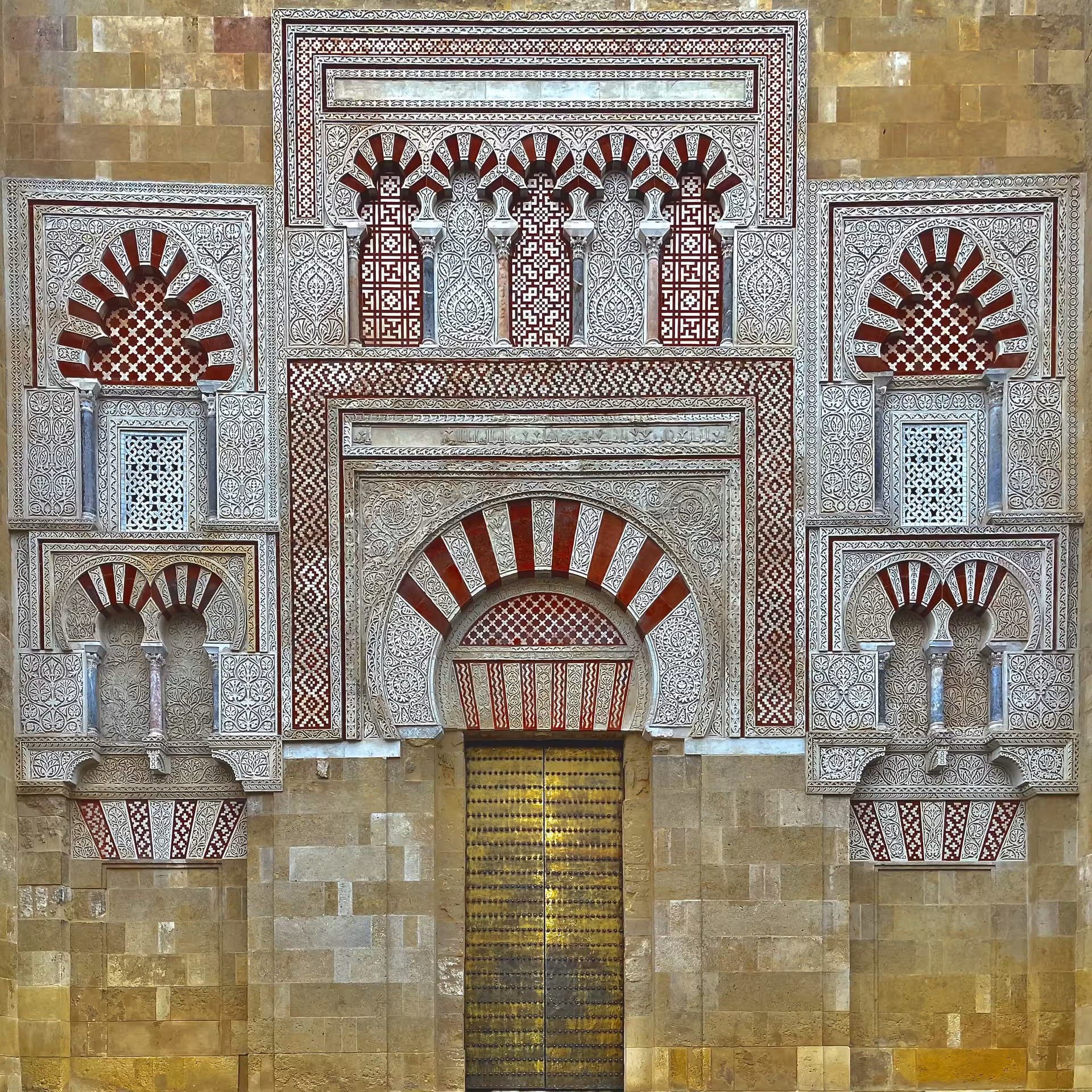 Ornate red-and-white horseshoe arch facade at Córdoba Mezquita-Catedral, must-see monument tour stop