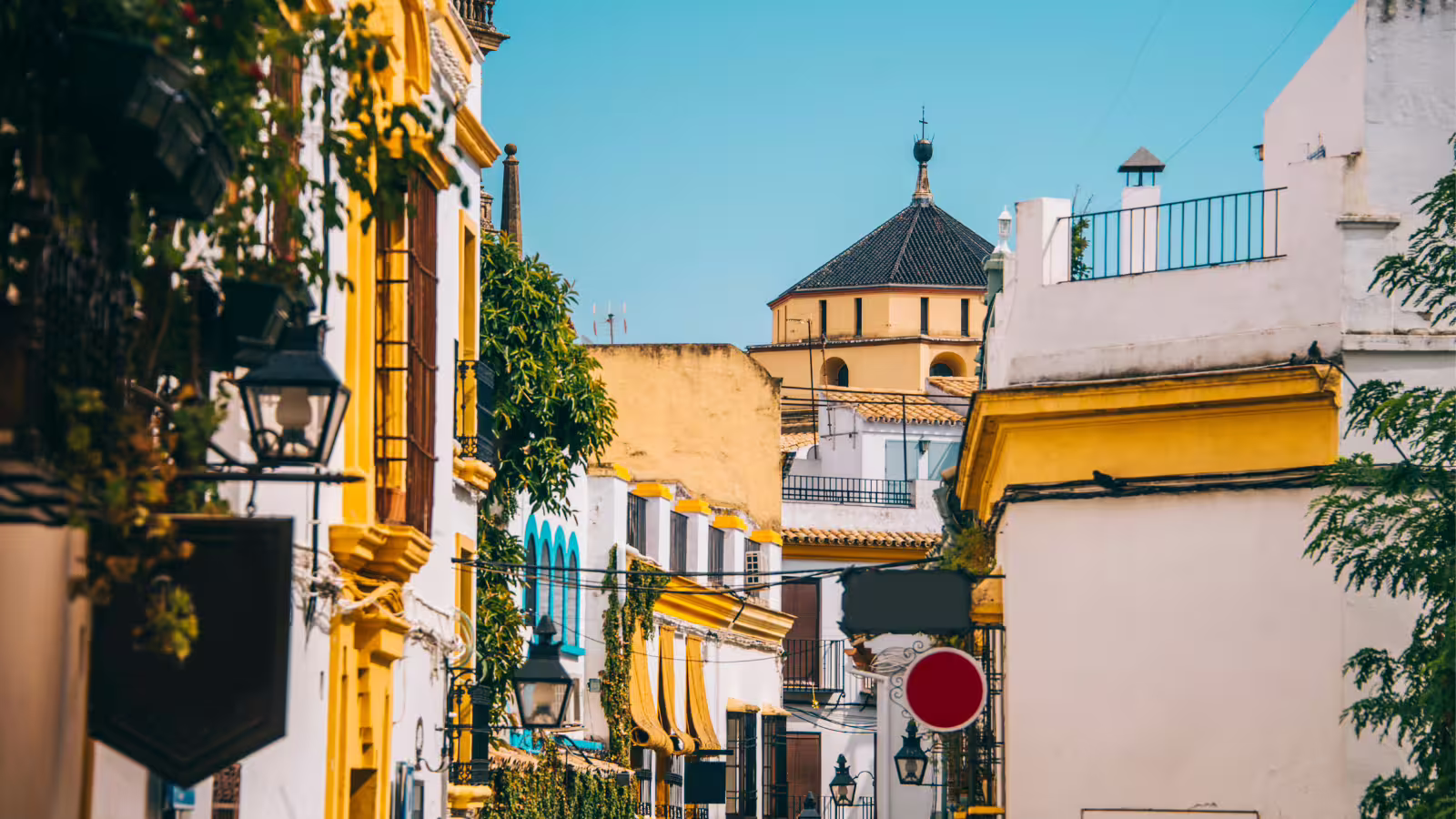 Charming Cordoba old town street with whitewashed houses and yellow facades on a guided group walking tour