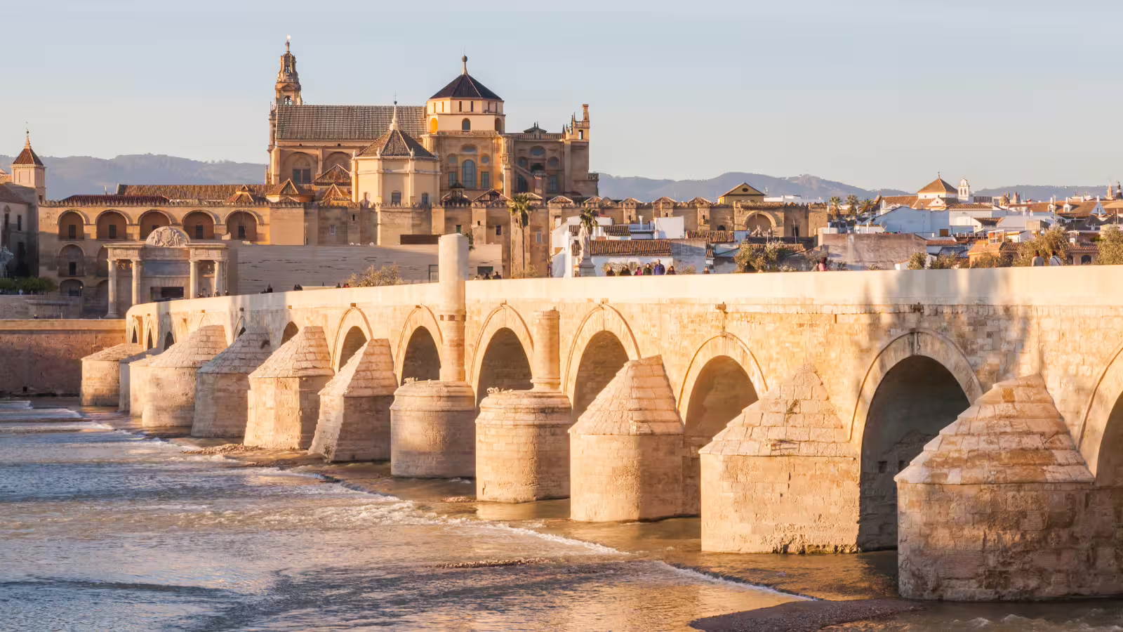 Roman Bridge and Mezquita-Catedral skyline at sunset, iconic view on a Córdoba private walking tour in Spain