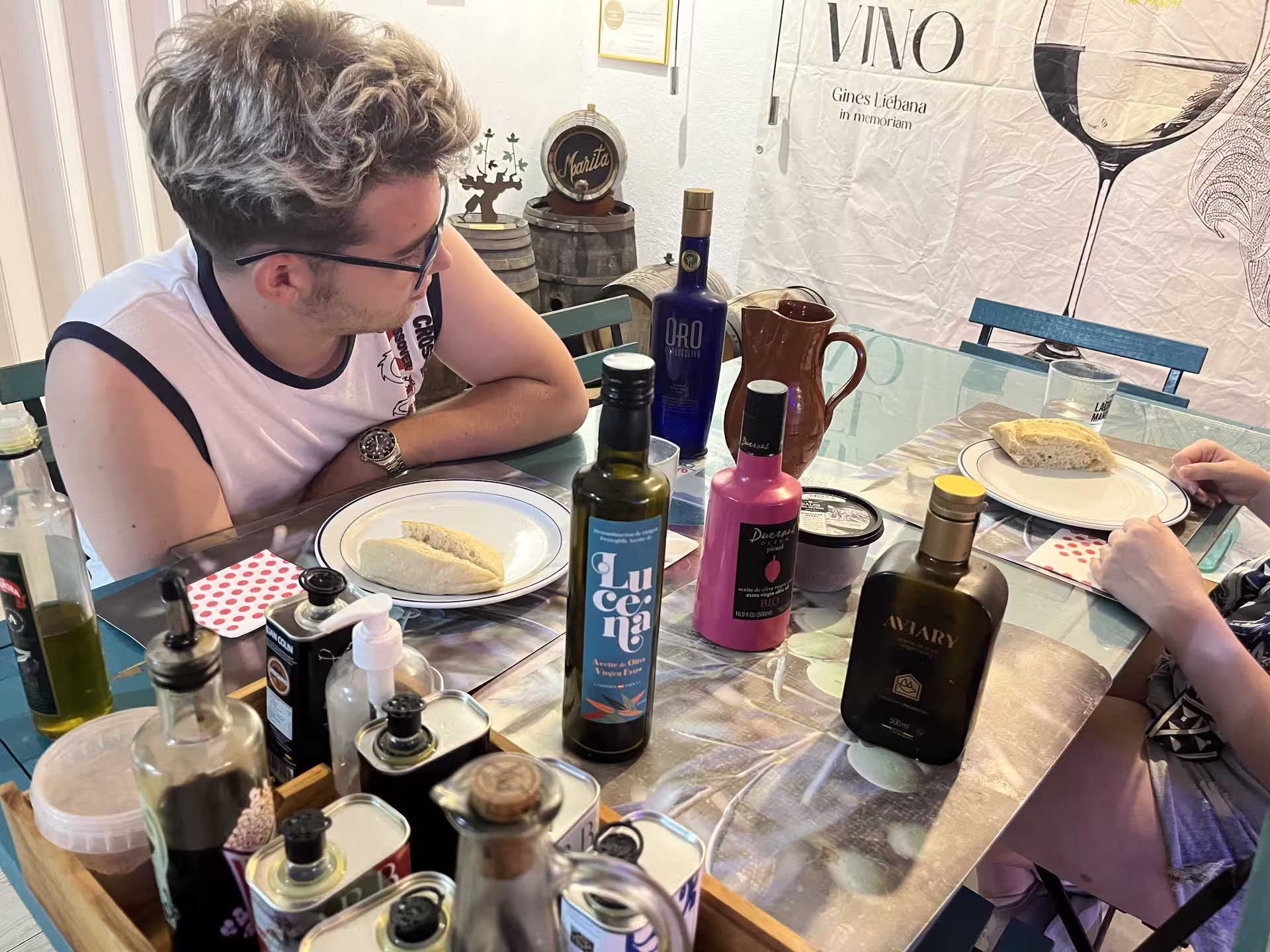 Guests enjoy a Cordoba tasting experience with olive oils and fresh bread on a decorated table.