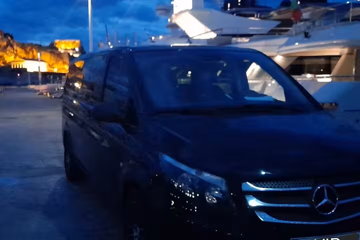 Corfu port private transfer at night with luxury van by marina, reliable airport to cruise terminal ride