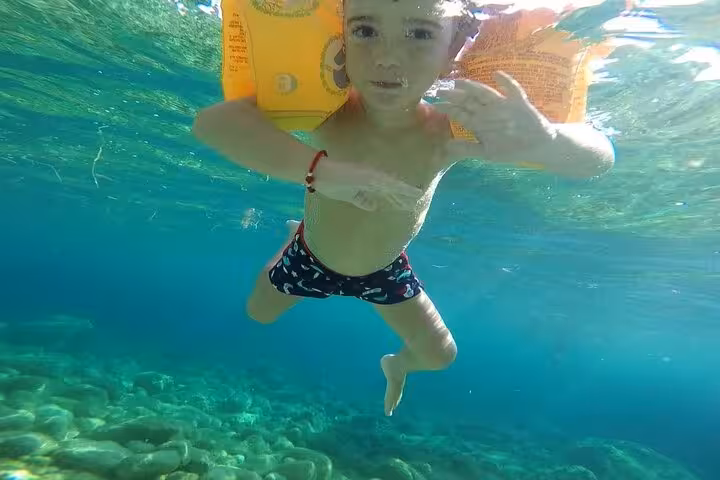 Underwater swim in clear Corfu sea at Glyfada, a fun stop on the private Paleokastritsa beach tour