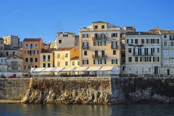 Pastel Venetian buildings on Corfu Old Town seafront promenade, featured on a private guided walking tour