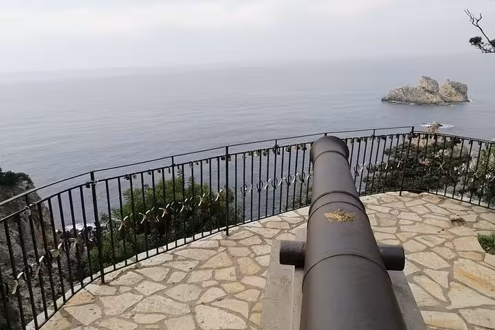 Viewpoint cannon overlooking Palaiokastritsa cliffs and Ionian Sea, photo stop on Corfu small group tour
