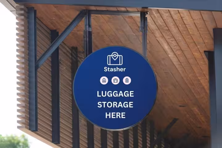 Stasher luggage storage sign outside a Corfu Port partner location for secure bag drop near the cruise terminal