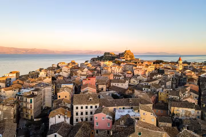 Sunset view over Old Corfu Town rooftops and Ionian Sea, ideal for a private walking guided tour